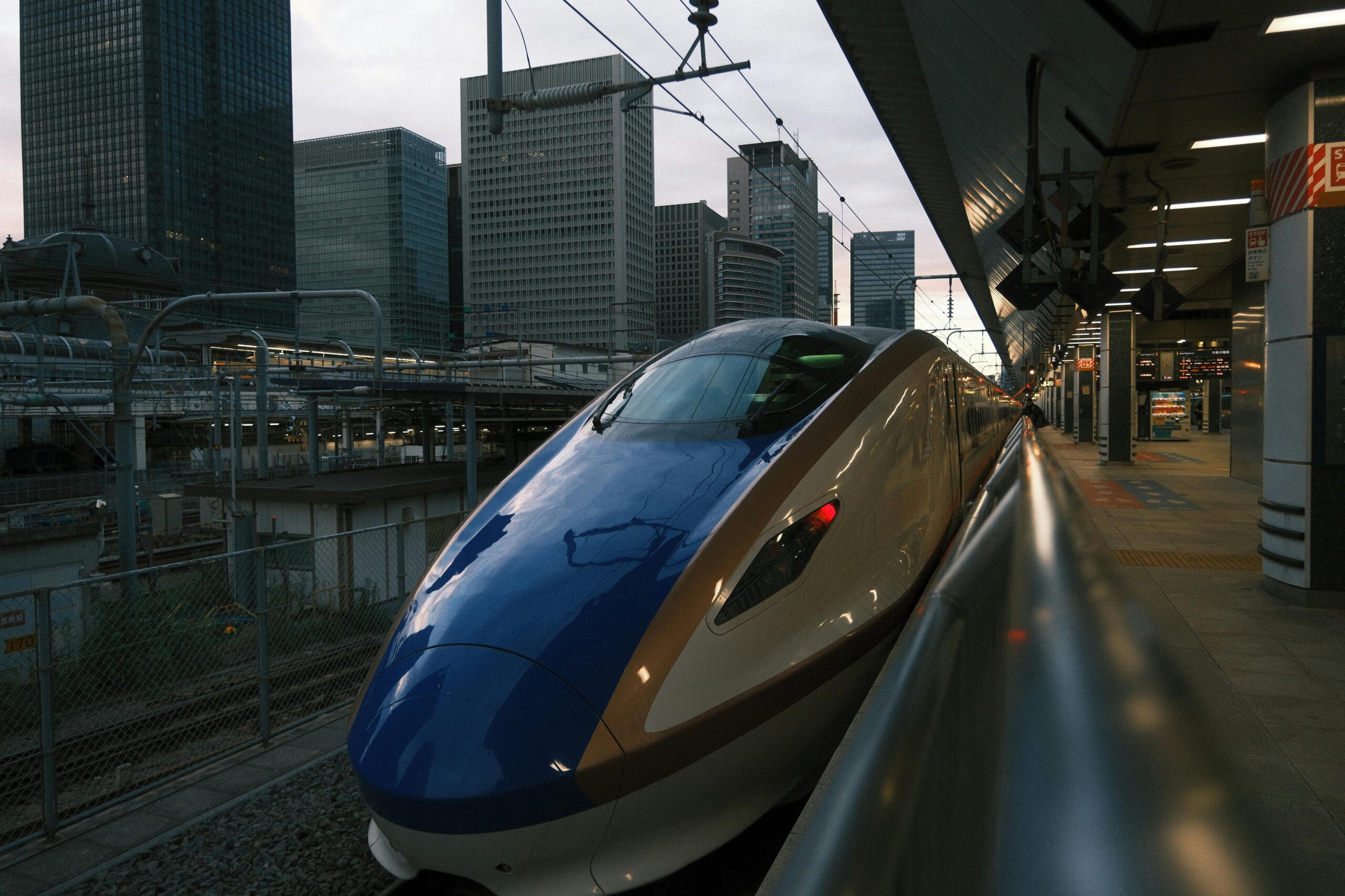 High-speed Shinkansen train at Tokyo Station in Chiyoda City during the day.