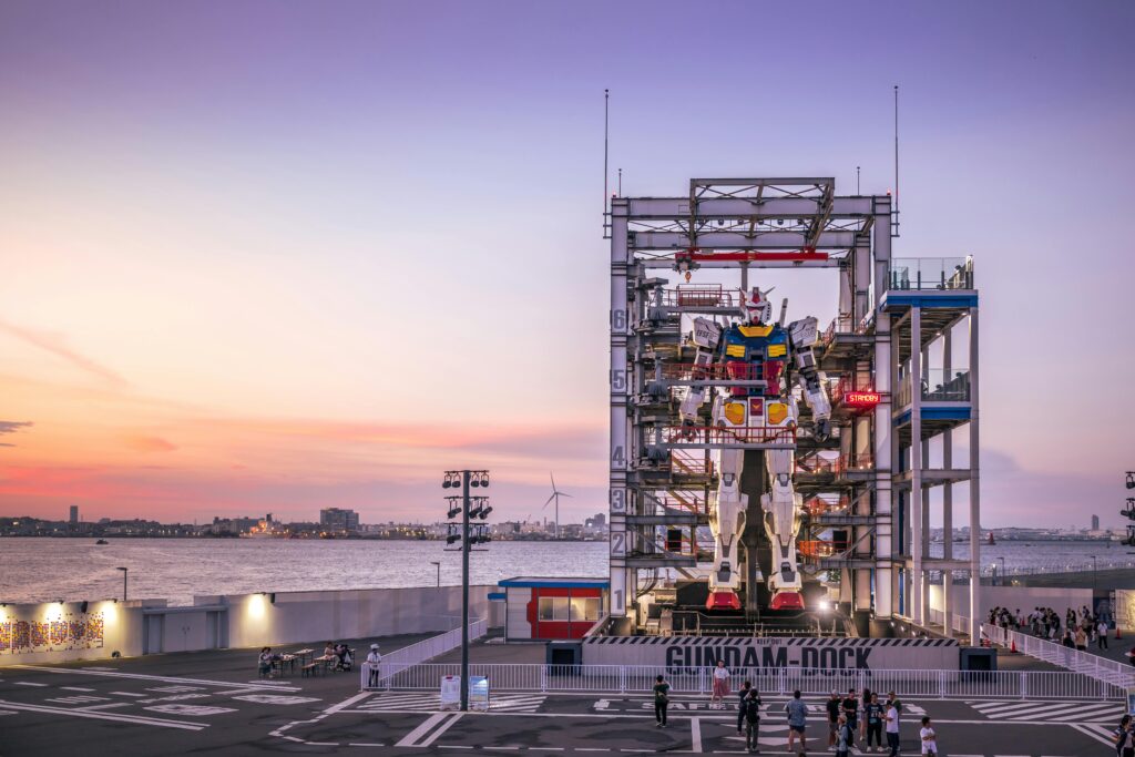 A stunning sunset view of the Gundam robot at Yokohama's waterfront, Japan.